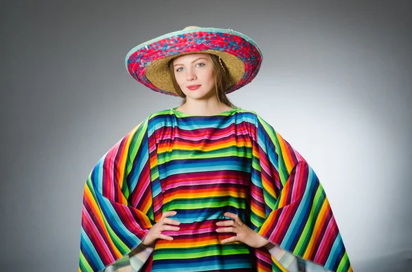 Girl in mexican vivid poncho against gray — Stock Photo, Image