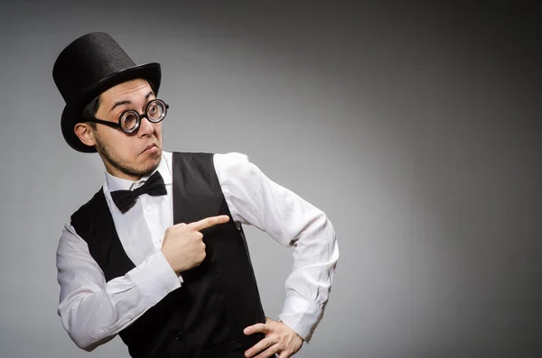 Young man in classical black vest and hat against gray — Stock Photo, Image