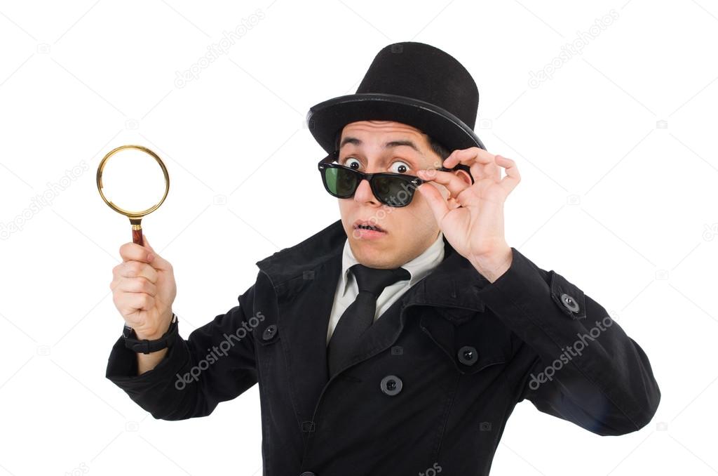 Young detective in black coat holding magnifying glass isolated