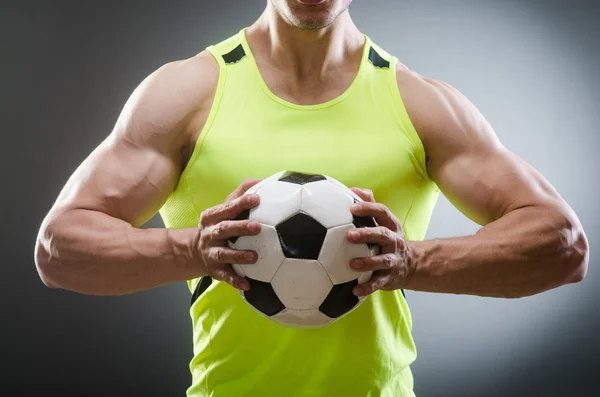 Muscular man with football ball — Stock Photo, Image