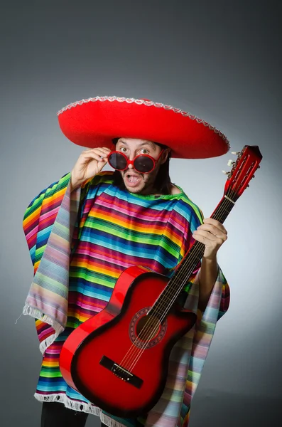 Mexican playing guitar wearing sombrero Royalty Free Stock Photos