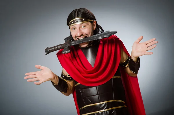 Roman warrior with sword against background — Stock Photo, Image