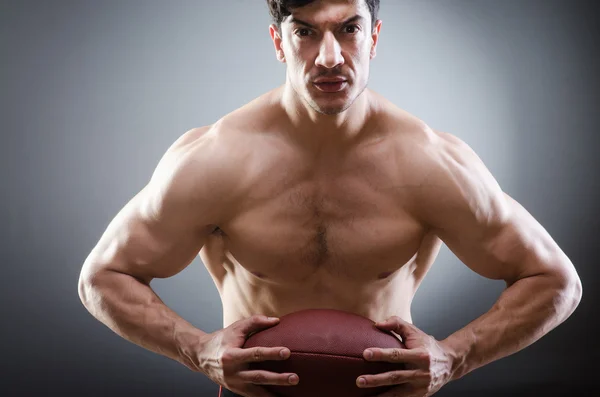 Muscular man with american football — Stock Photo, Image