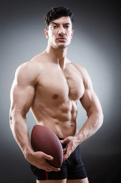 Muscular man with american football — Stock Photo, Image