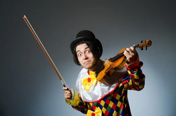 Grappige viool clown speler in muzikaal concept — Stockfoto