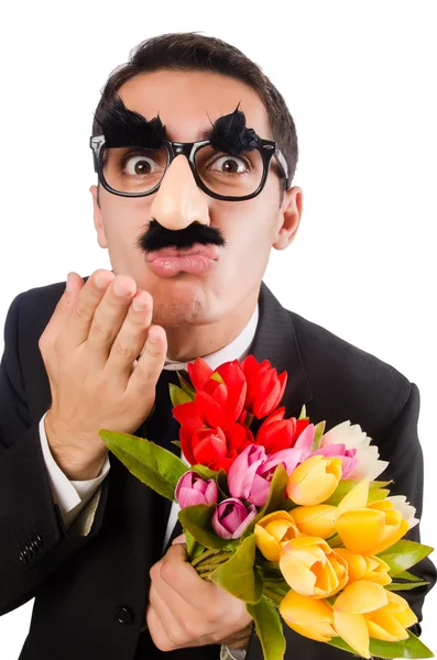 Grappige mens met bloemen geïsoleerd op wit — Stockfoto