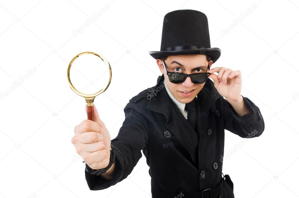 Young detective in black coat holding magnifying glass isolated 