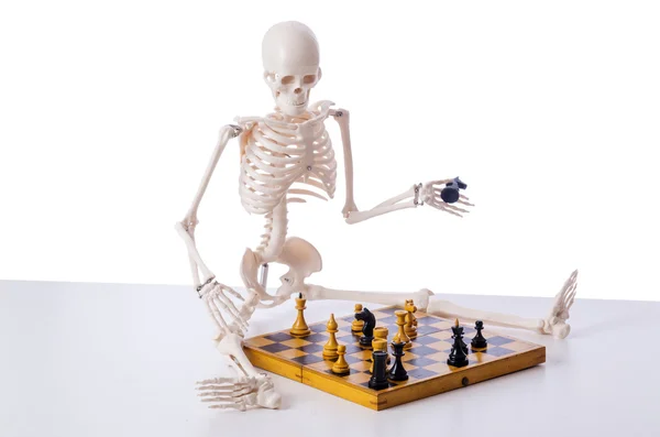 Skeleton scratches head trying to figure out next chess move Stock Photo -  Alamy