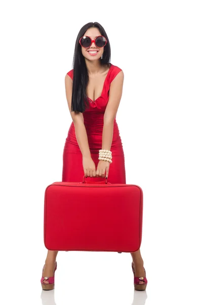 Kobieta w czerwonej sukience z walizką na biały — Zdjęcie stockowe