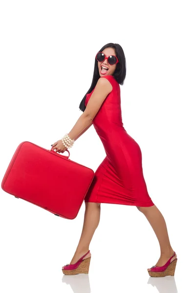 Frau im roten Kleid mit Koffer auf weißem Grund — Stockfoto