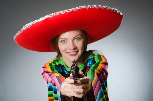 Menina no mexicano vívido poncho segurando pistola — Fotografia de Stock