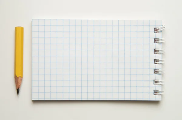 Pad and pencil on white — Stock Photo, Image