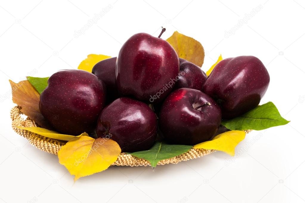 Basket of dark red apples on a white background