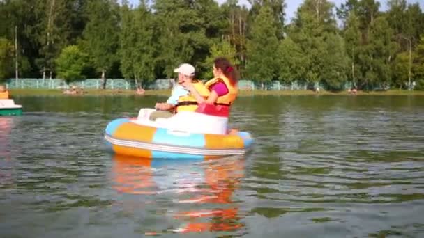 Сын и мать в резиновой лодке — стоковое видео