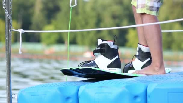 Wakeboarder lacing protection shoes — Stock Video