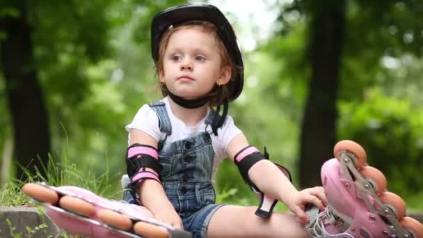 Fille est assise avec des rouleaux — Video