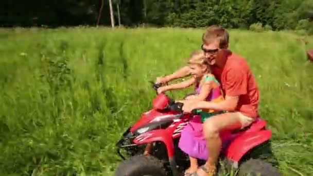 Father with daughter rides on ATV — Stock Video