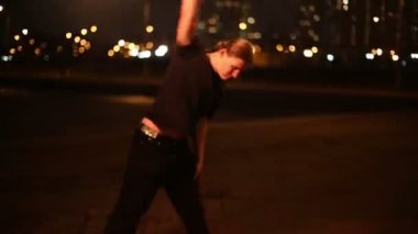 Young man juggles with burning mace