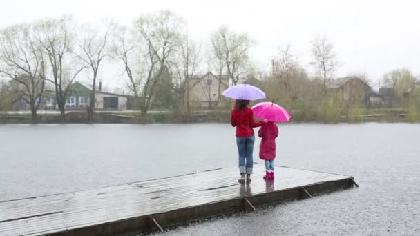 Woman and daughter with umbrellas — Stock Video