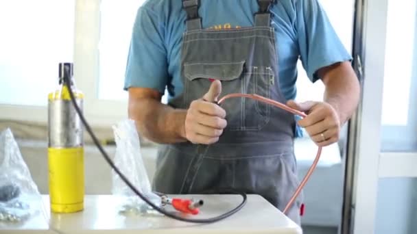 Worker welds copper tube — Stock Footage Worker welds copper tube Stock Footage