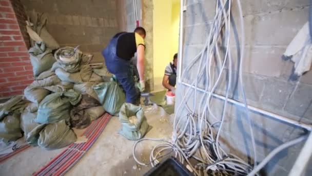 Men prepare doorway to door installation. — Stock Video