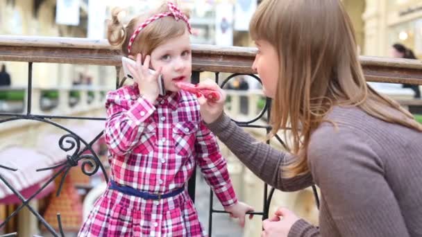 Makeup artist applies lipstick  to girl — Stock Video