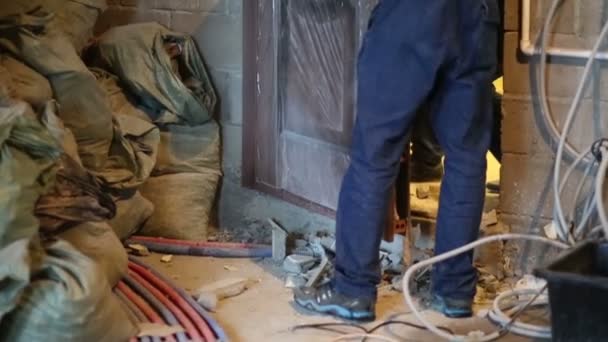 Two men in overalls install door — Stock Video