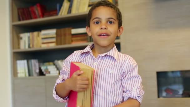 Mulatto boy holds book — Stock Video