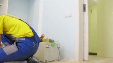 Worker assembles wardrobe 