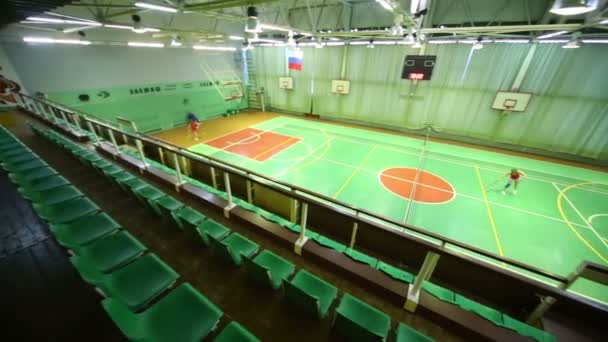 Women play tennis in sport hall — Stock Video