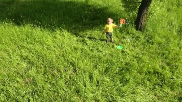 Little boy blowing bubbles — Stock Video