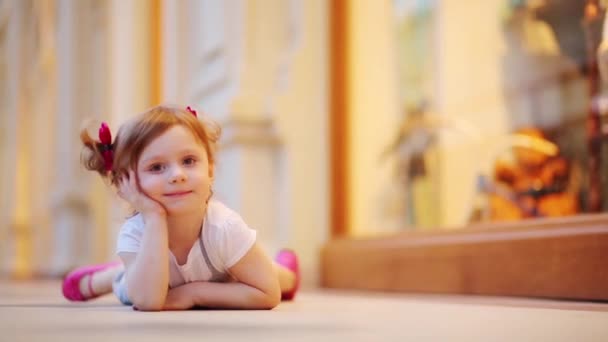 Little cute girl lies on floor — Stock Video