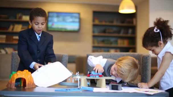 Boys playing with toy train and girl — Stock Video