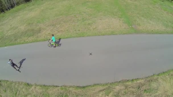 Jovens passeios de bicicleta por estrada — Vídeo de Stock