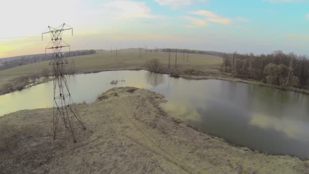 Small river with electricity line — Stock Video