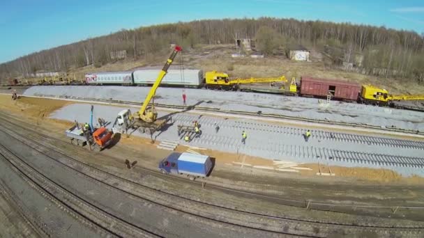 Workers building railway with crane — Stock Video