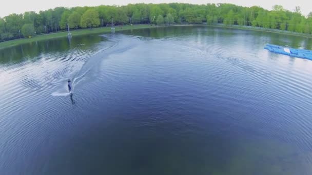 Surfer rides by pond — 图库视频影像