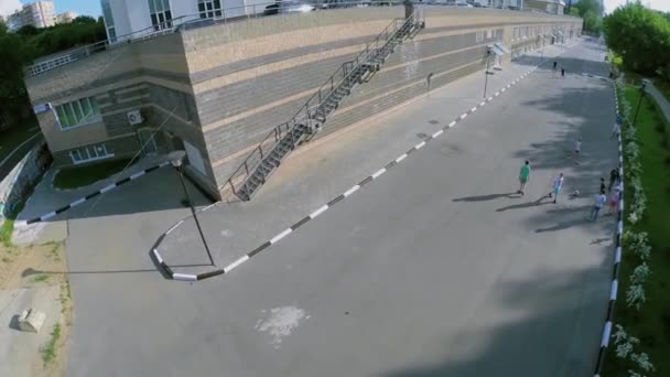 Group of kids play ball on road — Stock video