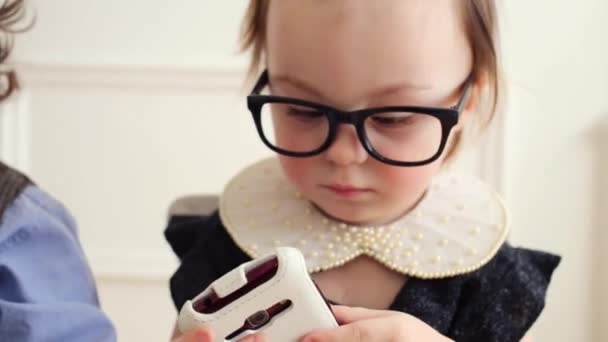 Close up of cute baby boy and baby girl in glasses — Stock Video