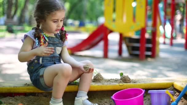 Chica haciendo una pequeña colina en sandbox . — Vídeo de stock