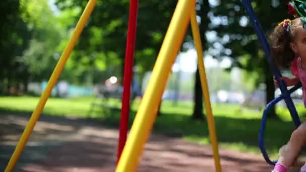 Curly girl  on the swing. — Stock Video