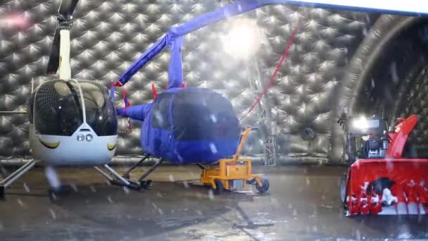 Hangar with two small helicopters — Stock Video