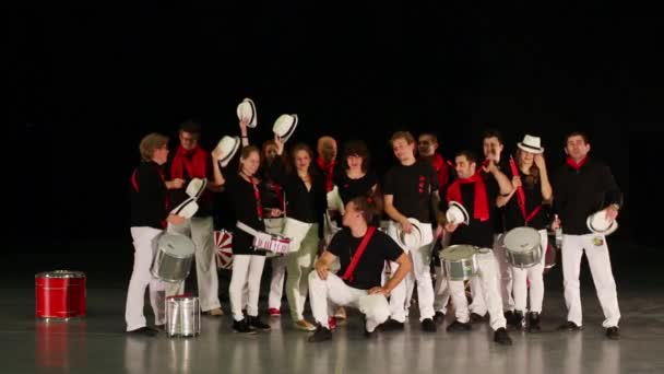 Musical group of fourteen people with drums wave by hats — Stock Video