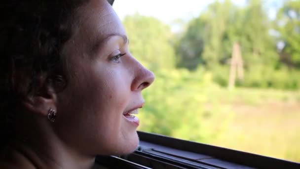 Woman looks in train window — Stock Video