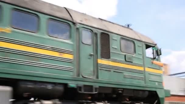 Big green freight train rides rails on railway at summer day — Stock Video