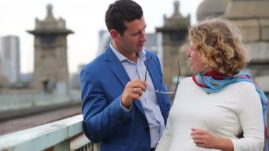 Young man removes sunglasses and put them on woman