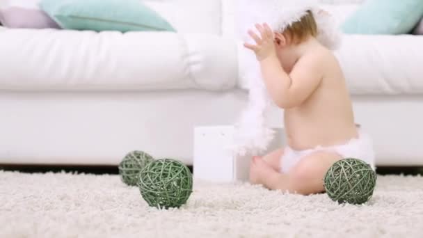 Schienale del bambino a piedi nudi rimuove il cappello e lo mette nella scatola — Video Stock