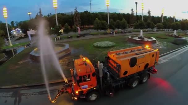 Spraying of water from truck with cistern at spring evening — Stock Video