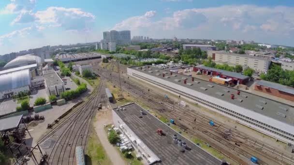 Городской пейзаж с железнодорожным депо и много железнодорожных путей весной — стоковое видео