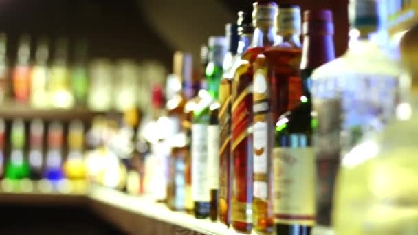 Shelf with many bottles of beverages in the restaurant. — Stock Video